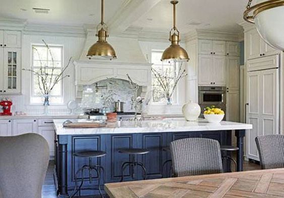 white kitchen navy island and gold accents