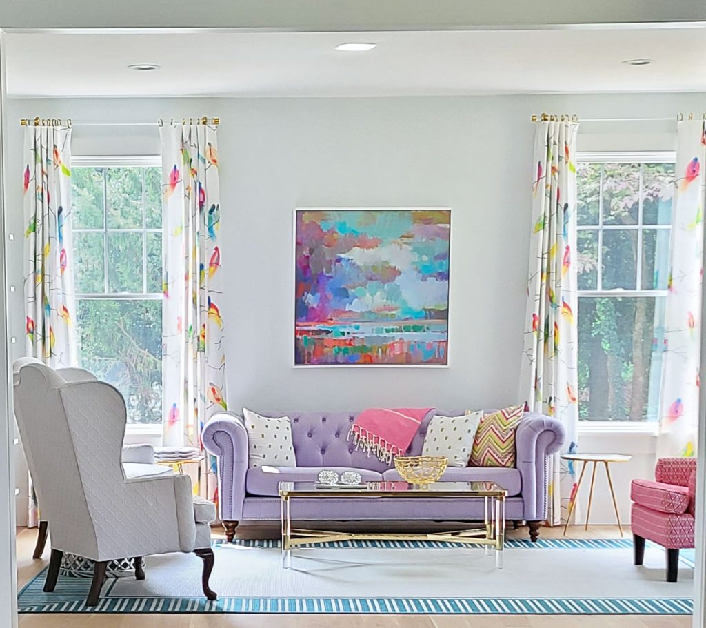 colorful living room design in Devon PA home. Off white walls, lavander couch, bird print window treatments