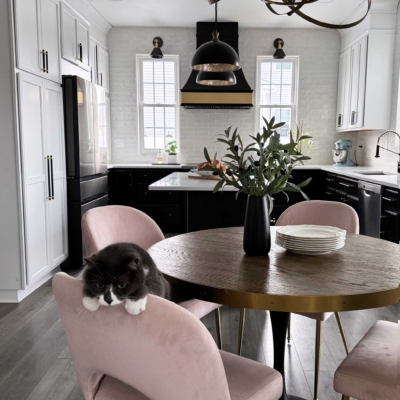 Kitchen remodel featuring two tone cabinets,, stove flanked by windows, island, small kitchen, cabinet storage