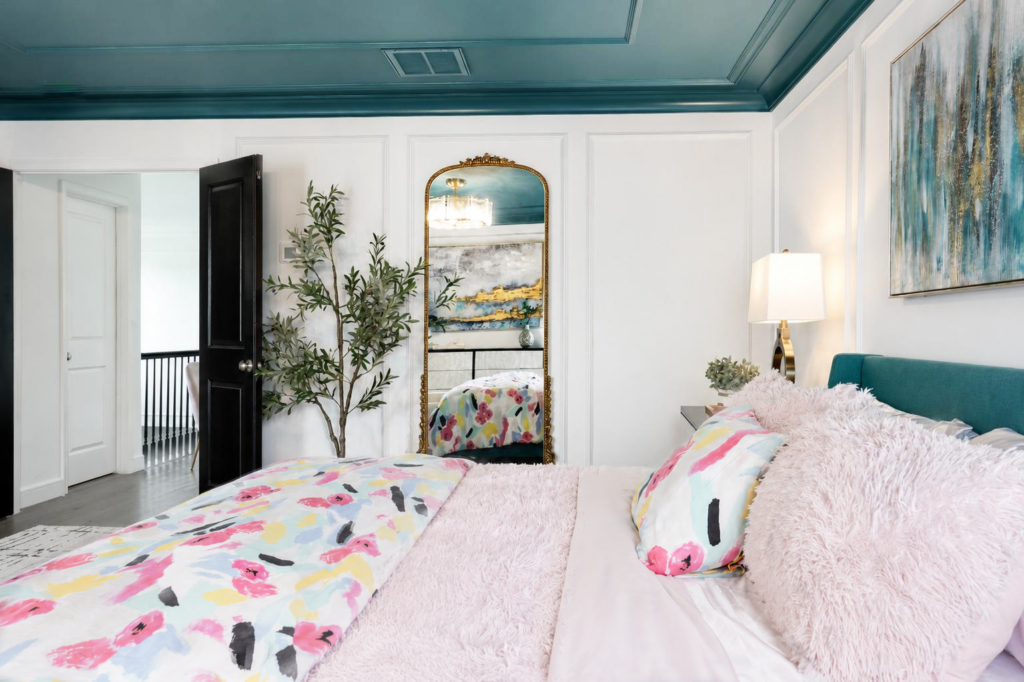 BedroomTealCeiling4 Primary bedroom with teal ceiling, white wall molding, colorful bedding and antique gold floor mirror in Chester County PA