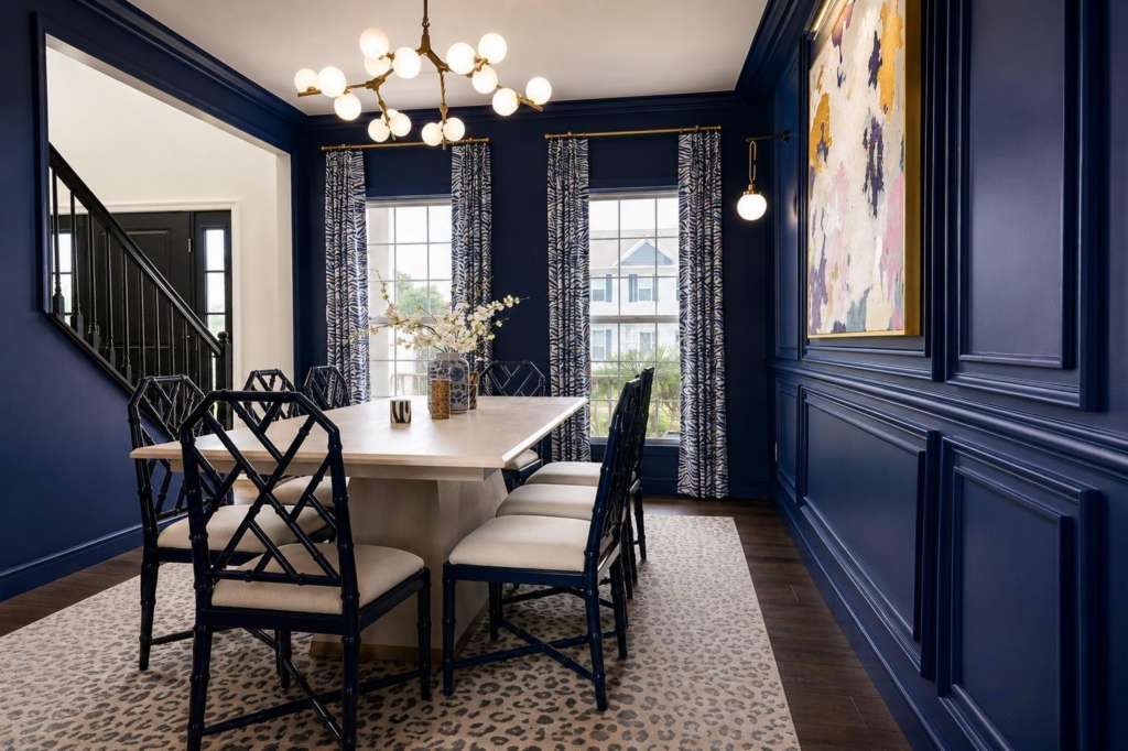 DiningRoomView3 Navy dining room with custom wall molding, patterned drapery, brass lighting and contemporary artwork