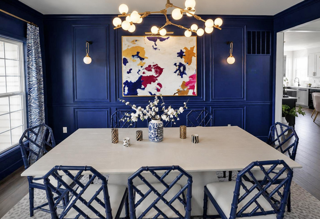 DiningroomViewStraight Bold navy dining room with custom wall millwork, colorful artwork and brass lighting in Chester County PA