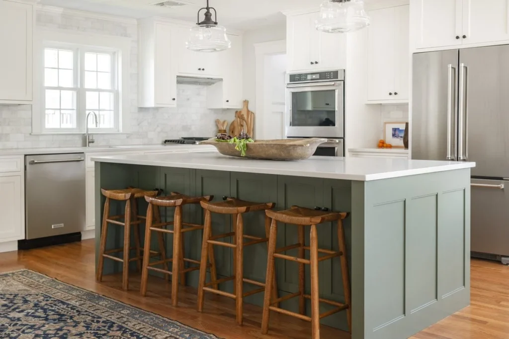 White kitchen design with sage green island