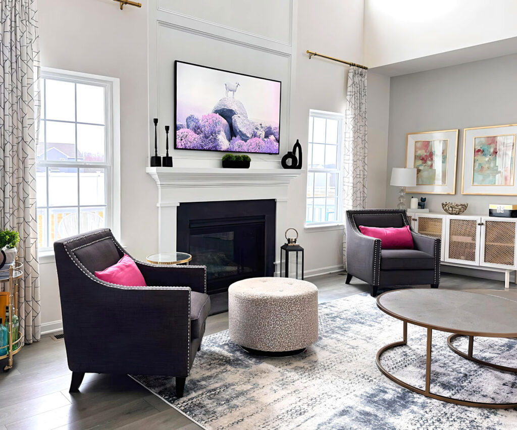 family room design featuring two story fireplace and custom moldings
