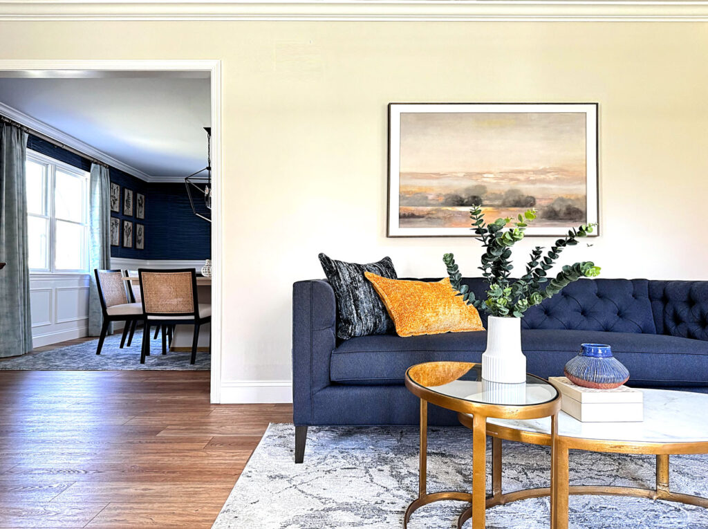 Full home interior redesign Main Line Philadelphia - living room featuring blue tufted sofa with gold accents