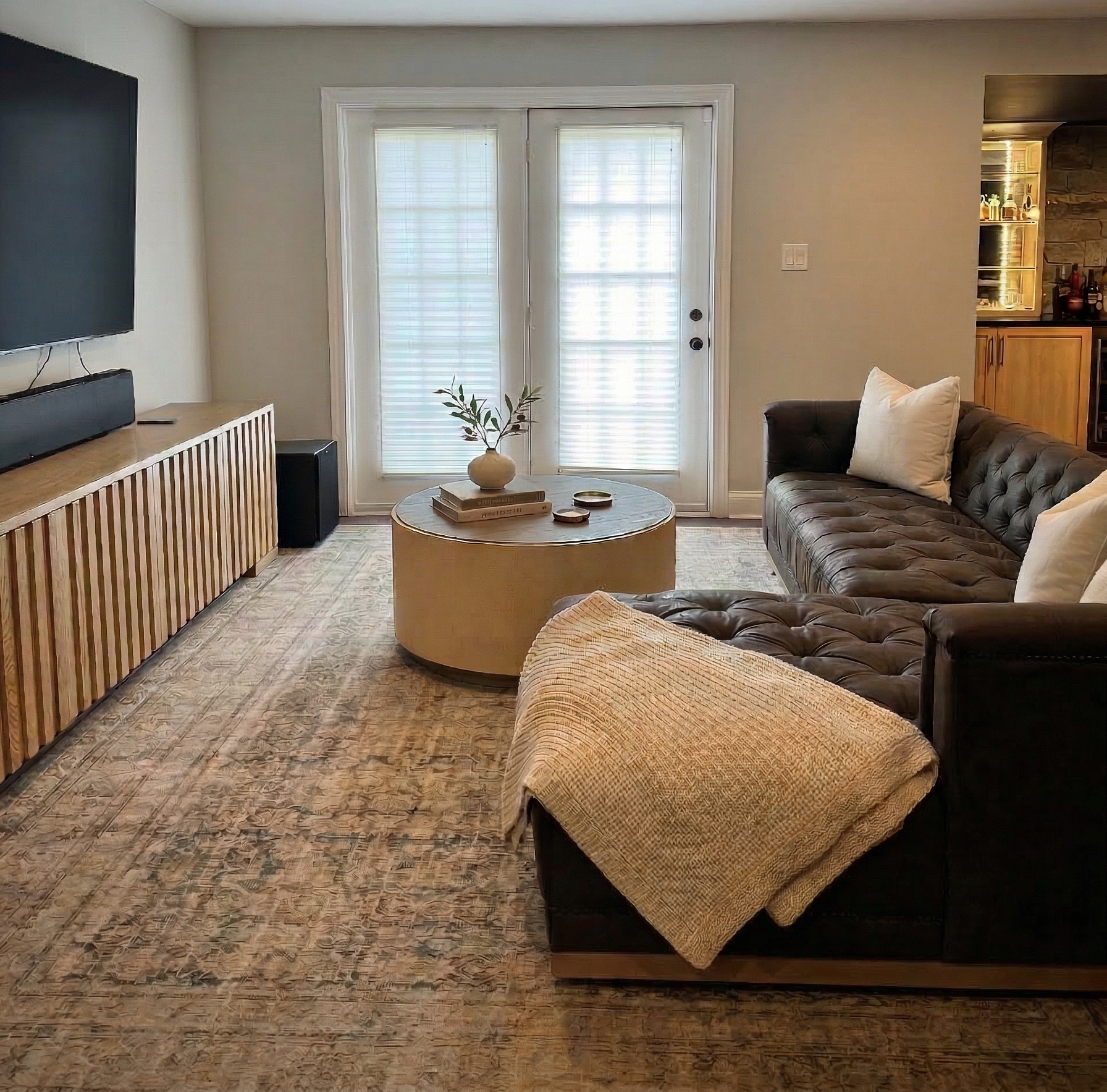 Basement remodel and design in chester count featuring Tv watching area overlooking custom bar