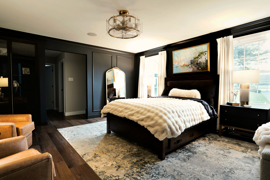 Main Line Luxury primary bedroom remodel with paneled walls, layered textures and cozy seating area