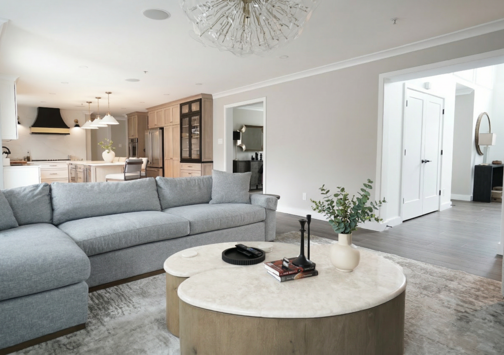 open concept family room with fireplace and view toward kitchen and entryway