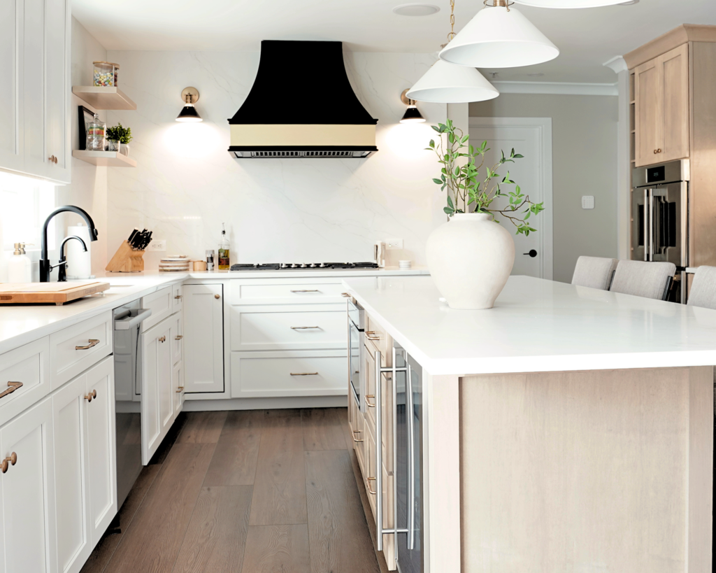 Modern cooking area with brass sconces, quartz backsplash, and professional range.