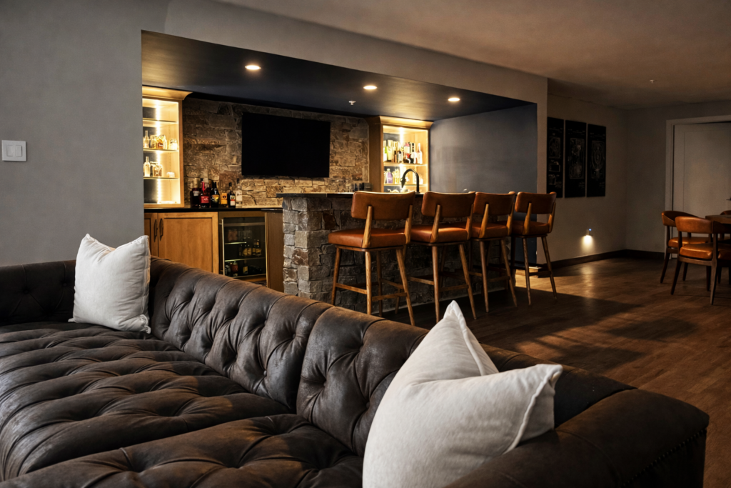 custom bar basement with stacked stone island, leather accents designed for entertainment