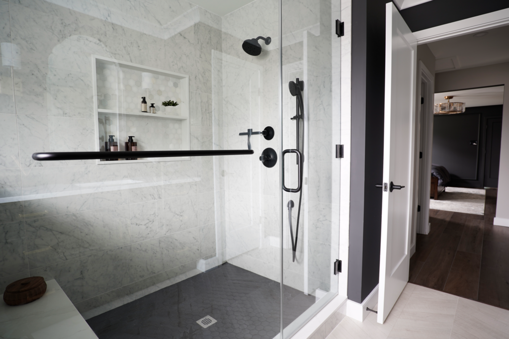 Spa like shower with marble walls, large niche and glass surround